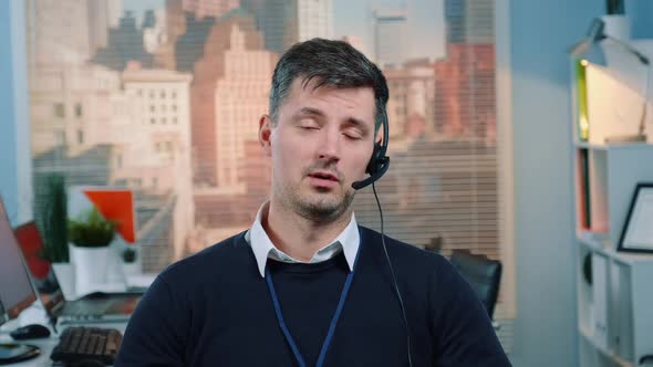 Portrait of Caucasian Young Man Talking To the Camera in a Call Center