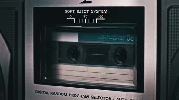 Audio Cassette Tape Rotates in Deck of an Old Tape Recorder