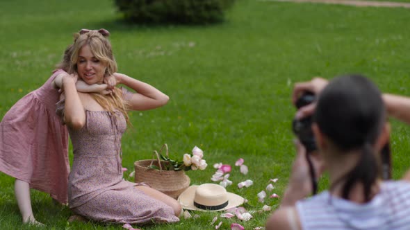 Daughter Hugs Her Mother Sitting on a Green Meadow in Summer in Nature