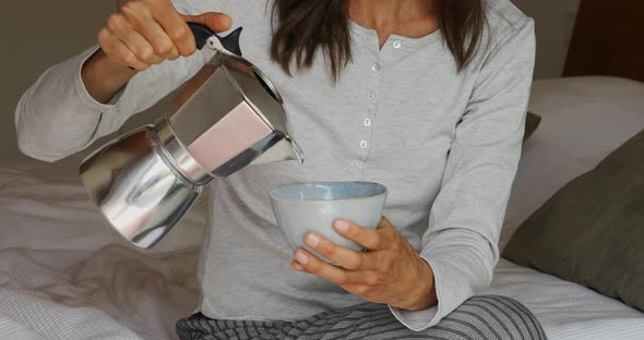 Woman pouring coffee into cup