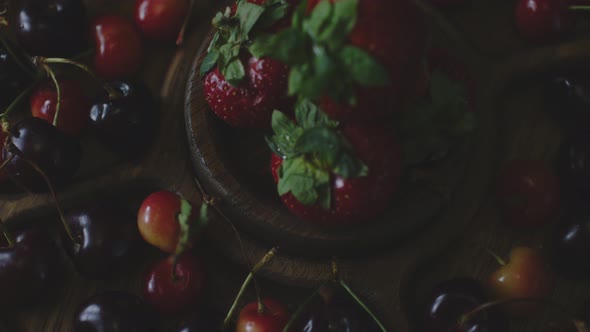 Menazhnitsa with Red Strawberries and Cherries on a Dark Background