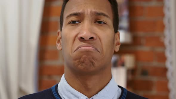 Shaking Head to No, Young African Man Sitting on Chair at Home