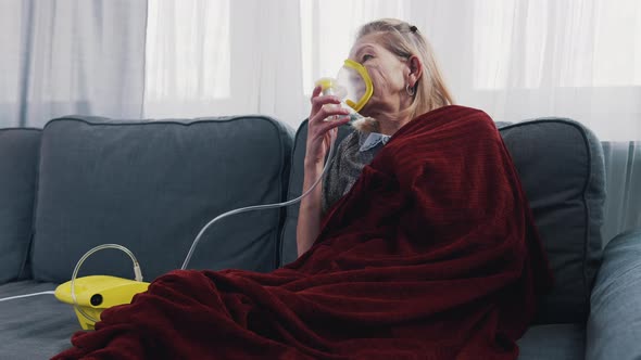 Old Woman Using Inhaler at Her Home