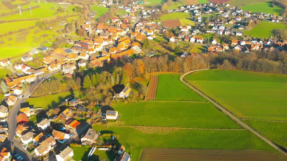 flight over small village in the countryside on a sunny afternoon