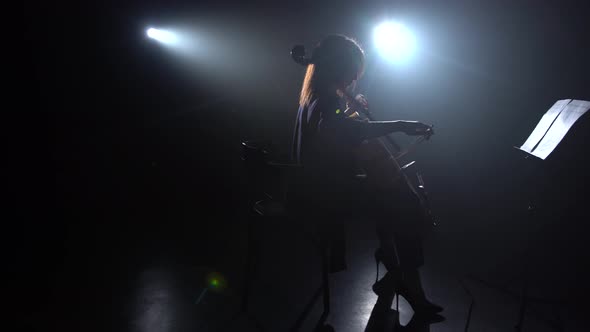 Cellist Performs on Stage with a Lantern