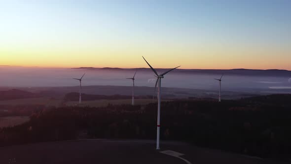 Wind Turbines in Twilight. Aerial View of Wind Farm Installation in Scenic Landscape