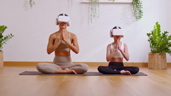 Relax mom and kid doing yoga at home together,VR goggles in modern lifestyle.Practicing yoga workout