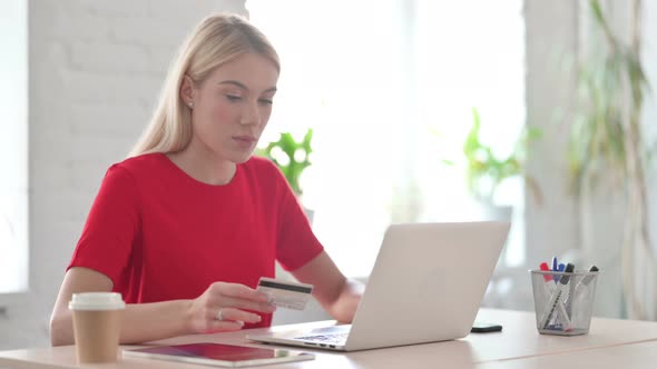 Young Blonde Woman Having Online Payment Failure on Laptop in Office