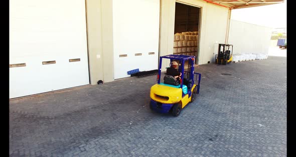 Warehouse worker driving forklift