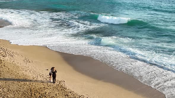 Girls take pictures on the beach Aerial view 4 K