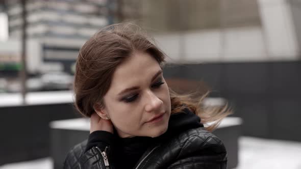 Portrait of Brunette Woman at Windy Winter Day in City Pensive Lady is Walking Alone