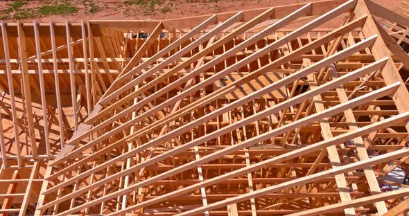 Installation of Wooden Beams at Construction the Roof Truss System of the House