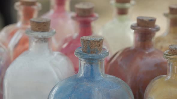 powder dyes of assorted colors to paint in a glass bottle