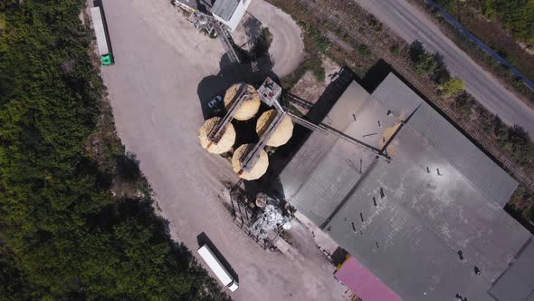 Aerial view of a flour mill with storage bins and loading areas.