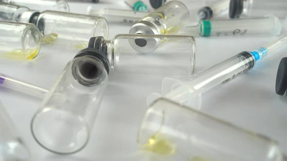 Syringes and ampoules on a white background.