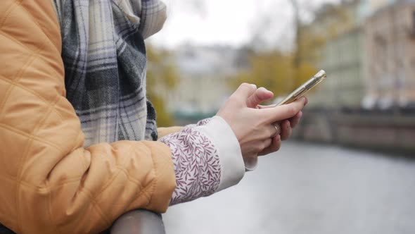 Woman Uses a Smartphone, Writes a Message, Chatting, Looking for Information in the Phone. Close-up.