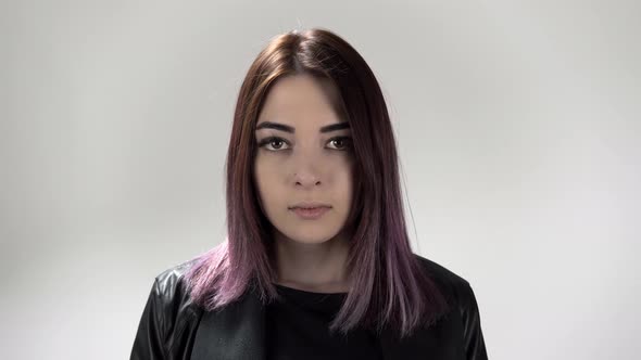 Portrait of Young Angry Woman Who Is Screaming on the White Background