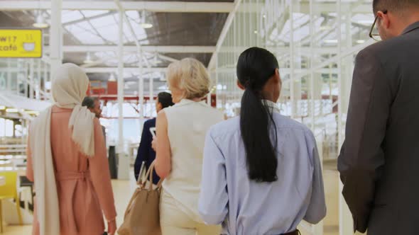 Business people talking and walking in a conference foyer