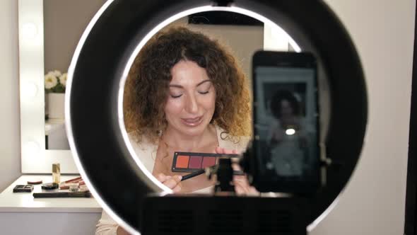 Wellgroomed Middleaged Beauty Blogger Talks About Fashion Trends in Eye Makeup