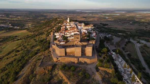 Monsaraz castle and village with overlooking surrounding landscape, Portugal. Aerial backward ascend