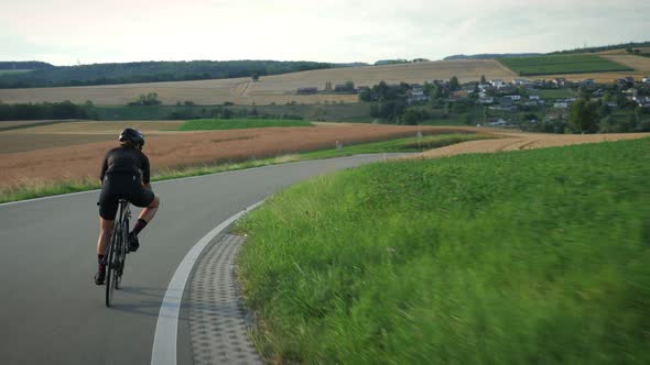 Cyclist descending fast from mountain hill