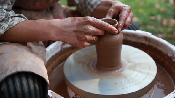 Potter Makes a Pot on a Potter's Wheel