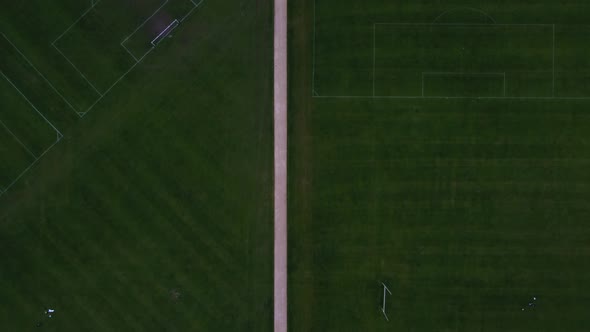 Topdown View of a Path Bisecting Football Fields in a Recreational Ground