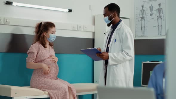 Pregnant Woman Talking to Doctor About Pregnancy