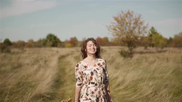 Portrait of Positive Smiling Woman Looking Into Camera at Sunset