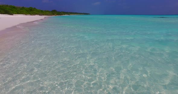 Luxury birds eye travel shot of a white sand paradise beach and aqua turquoise water background