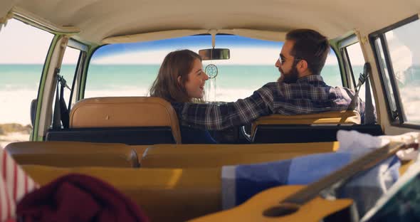 Young couple interacting with each other in van on a sunny day 4k