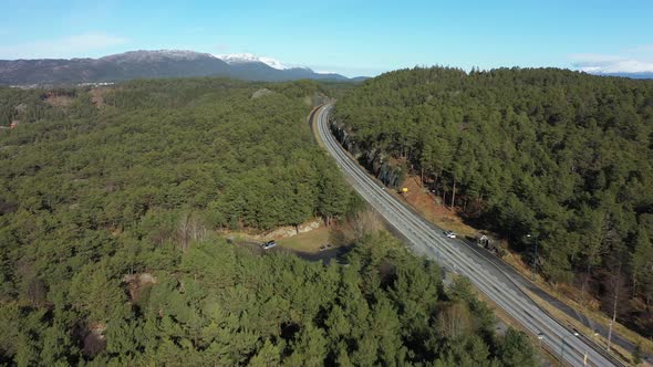 E39 coastal highway going through green forest on Stord Island close to digernessundet and bomlo bri