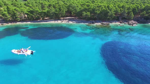 Aerial view of a boat passing sandy beach on the island of Brac, Croatia