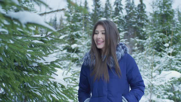 Girl admiring a snowy tree