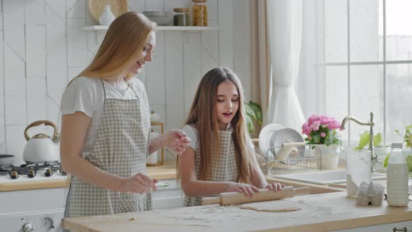Happy Caucasian Dancing Mom Teach Look Teen Girl Daughter Using Rolling Pin Preparing Dough for