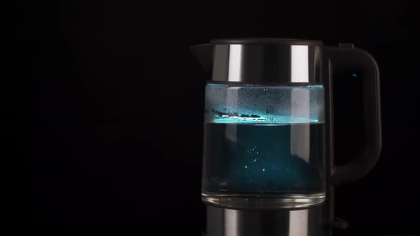 Boiling Water in a Glass Electric Kettle Rises in Bubbles in Slow Motion