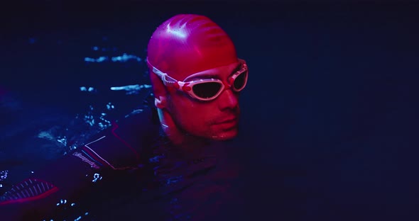 Portrait of Triathlon Athlete Swimmer Having a Break During Intense Training at Night