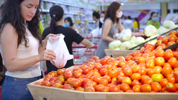 Pretty Young Woman Is Making Purchases in the Supermarket, Choosing Products at the Supermarket for