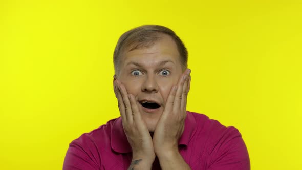 Portrait of Caucasian Man Posing in Pink T-shirt. Amazed Handsome Guy Shocked, Surprised, Say Wow