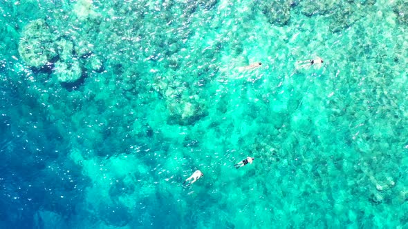 Aerial drone texture of marine tourist beach vacation by blue lagoon with white sand background of a