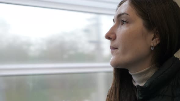 Woman in the Train. She Is Sitting and Looking Out the Window.