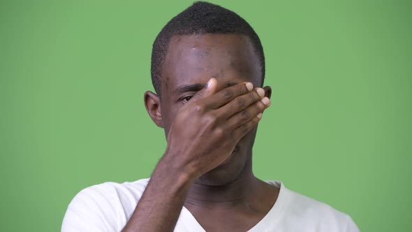 Young African Man Covering Eyes Not Wanting To See Something