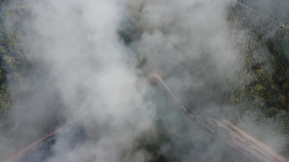 Aerial view look down fire smoke blow by wind