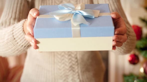 Closeup Footage of Young Woman Holding Beautiful Box with Gift Tied with Ribbon and Bow. Family