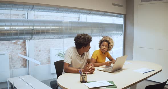 Two African American Workers Working in an Office or a Coworking Space