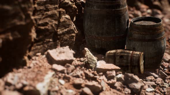 Old Wooden Vintage Wine Barrels Near Stone Wall in Canyon alt