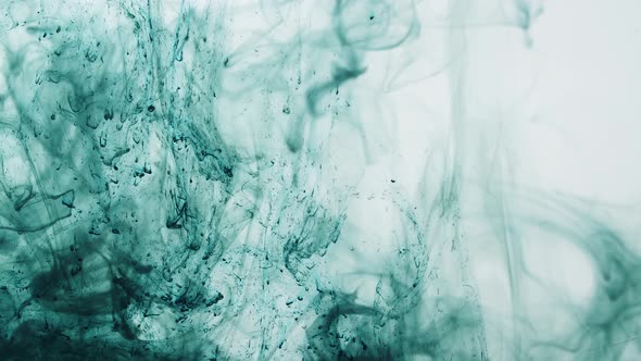 Green Ink Dissipating In Water On A White Background
