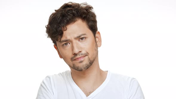 Young Handsome Man Listening Thinking Looking at Camera Over White Background