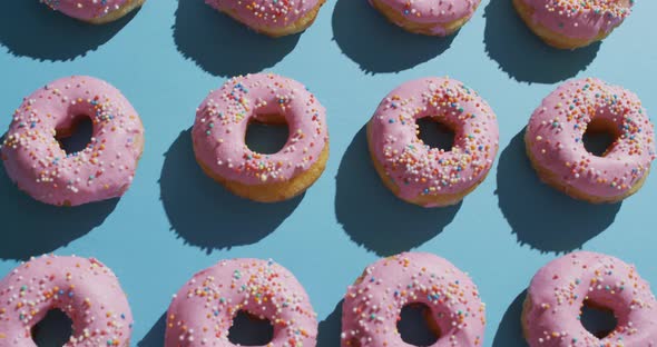 Video of donuts with icing on blue background