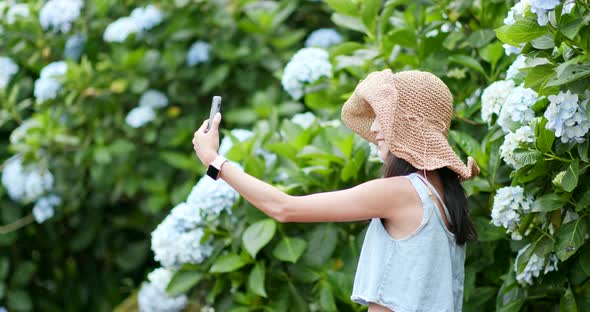 Woman taking self vlog on cellphone and talking to camera